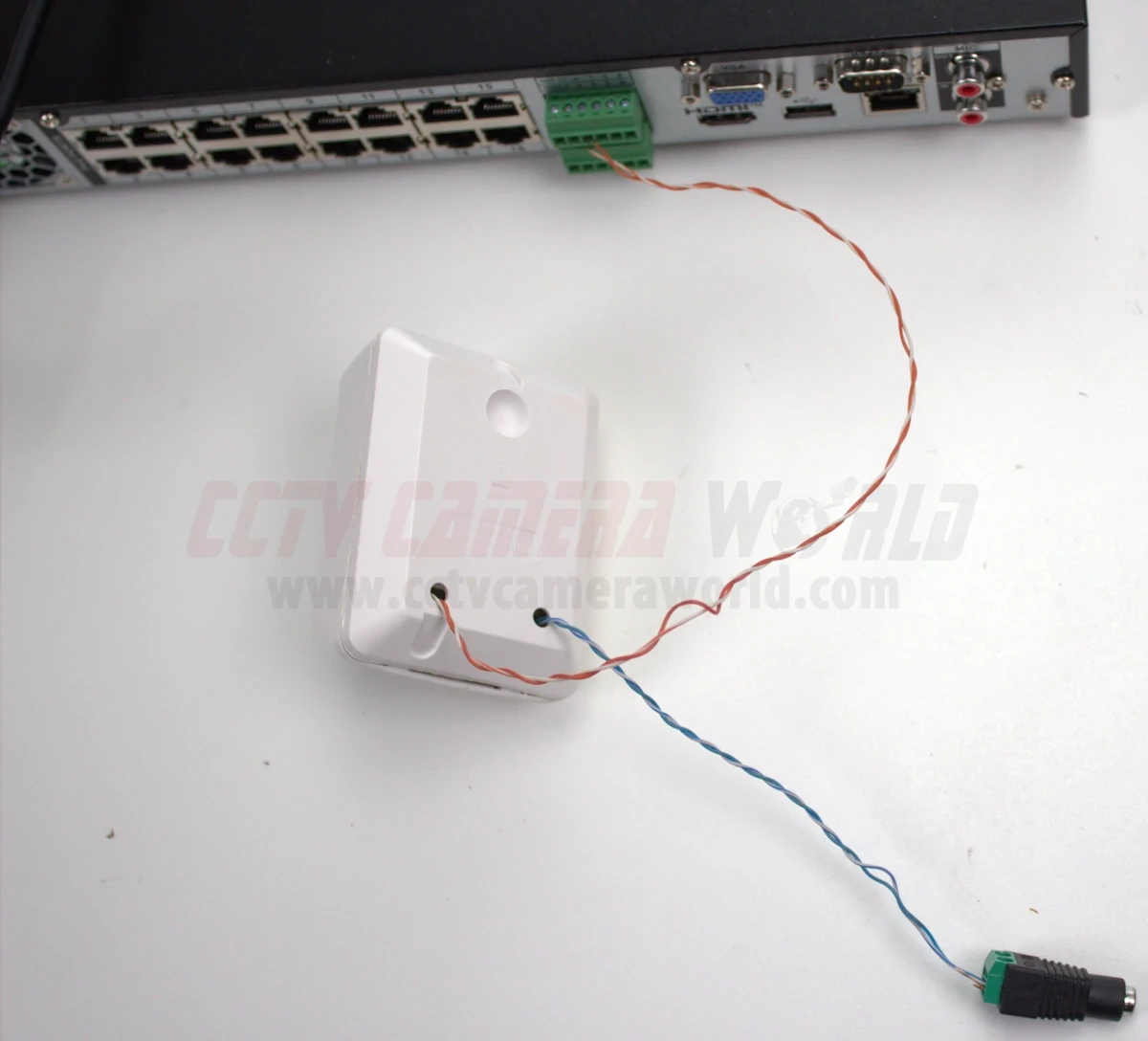 A PIR sensor wired into the alarm input on an NVR