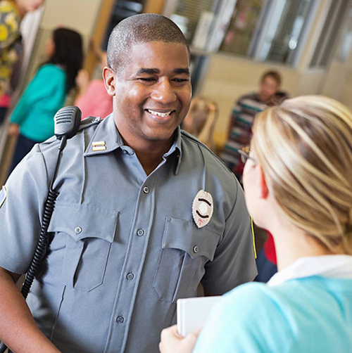 Police officer speaking to woman