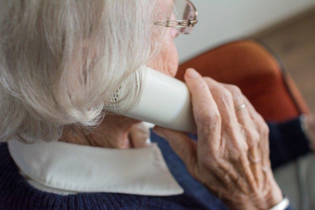 elderly woman speaking to someone on the phone