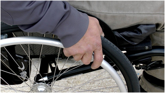 man gripping wheel chair